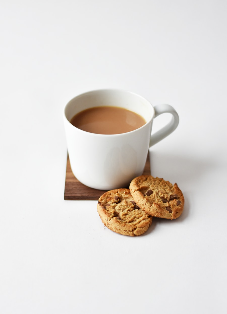 A brass cup of dark, strong chai on a wooden surface