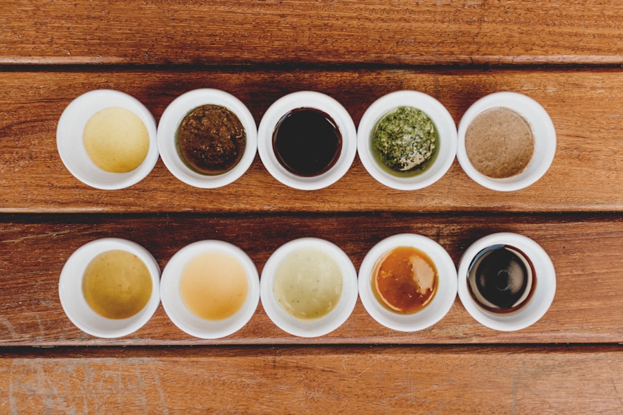 White ceramic cupping bowls filled with tea liquor of varying intensities on a wooden tasting table